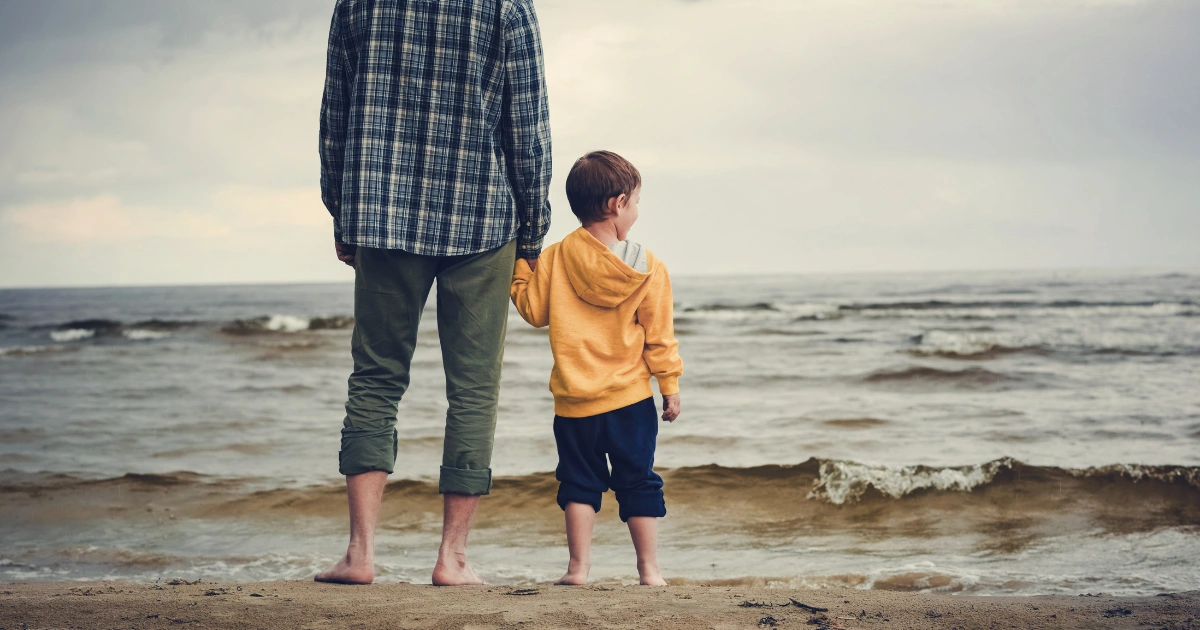 Inner Child the psychology. Little boy standing next to parent holding hands.